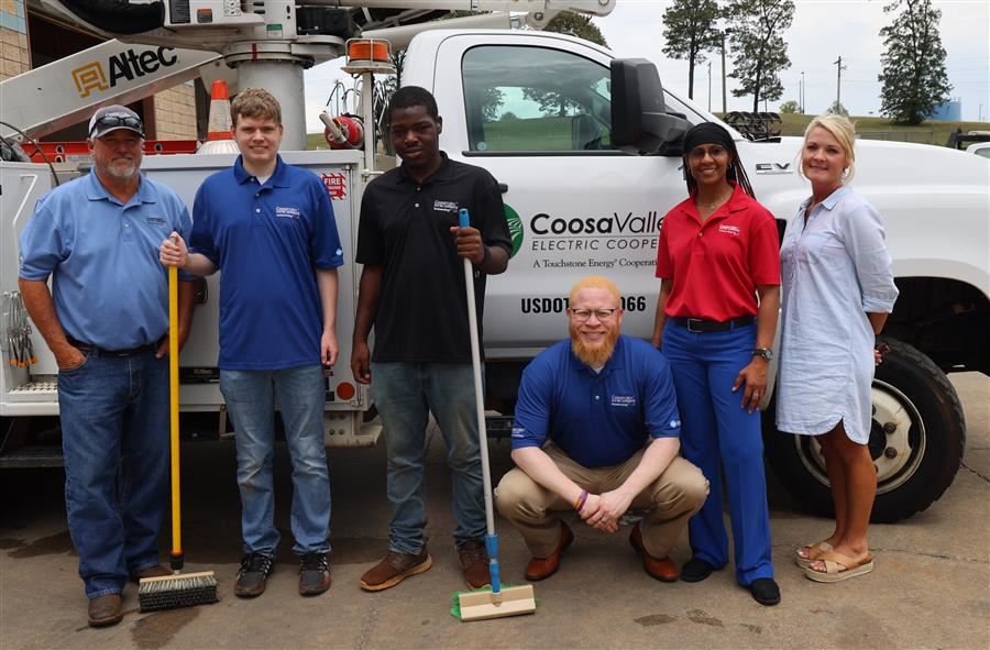 Left to Right: Robert Smith, Devin Hale, Isaiah Casey, Donte Little, Isis Mann and Lisa Bonner pose in front of a truck